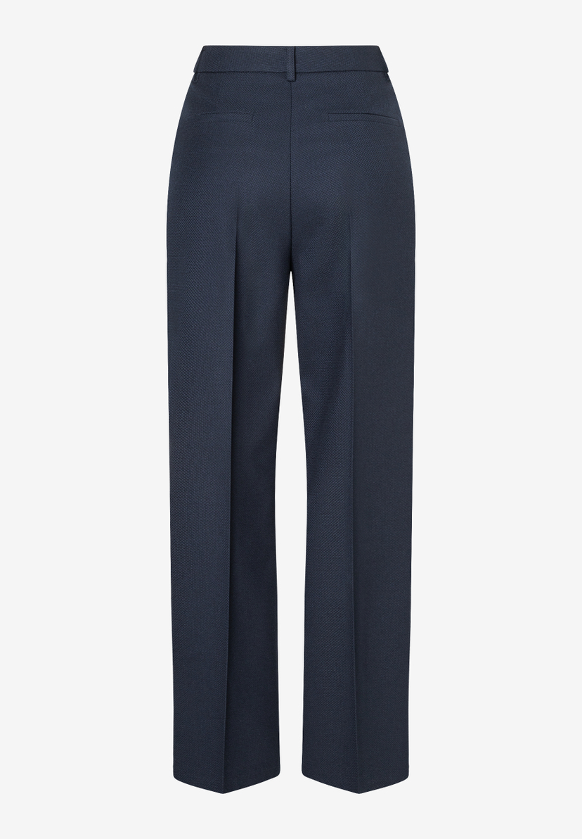 Dunkelblaue, knöchellange MORE & MORE Hose, Rückansicht. Dunkelblaue, knöchellange MORE & MORE Hose, Rückansicht.