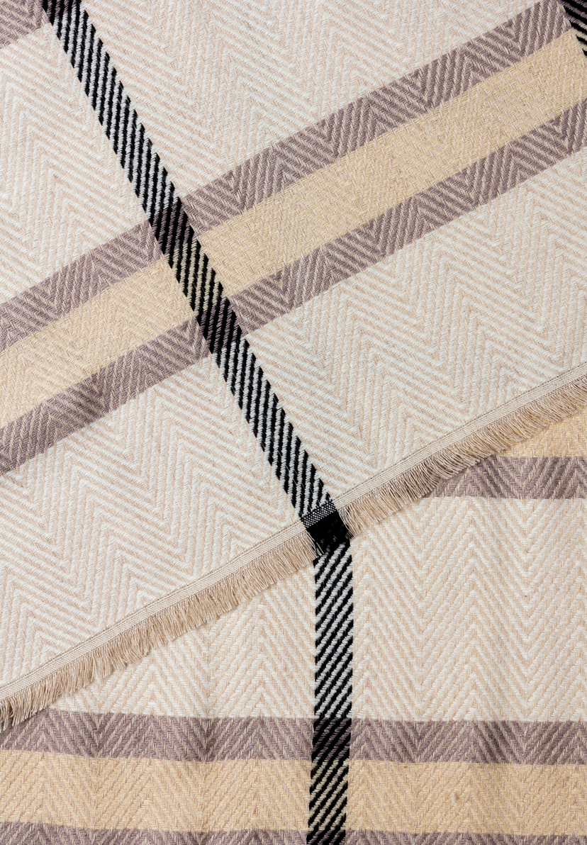 Nahaufnahme eines MORE & MORE Accessoires mit Fischgrätenmuster und Fransen in Beige-, Braun- und Schwarztönen. Nahaufnahme eines MORE & MORE Accessoires mit Fischgrätenmuster und Fransen in Beige-, Braun- und Schwarztönen.