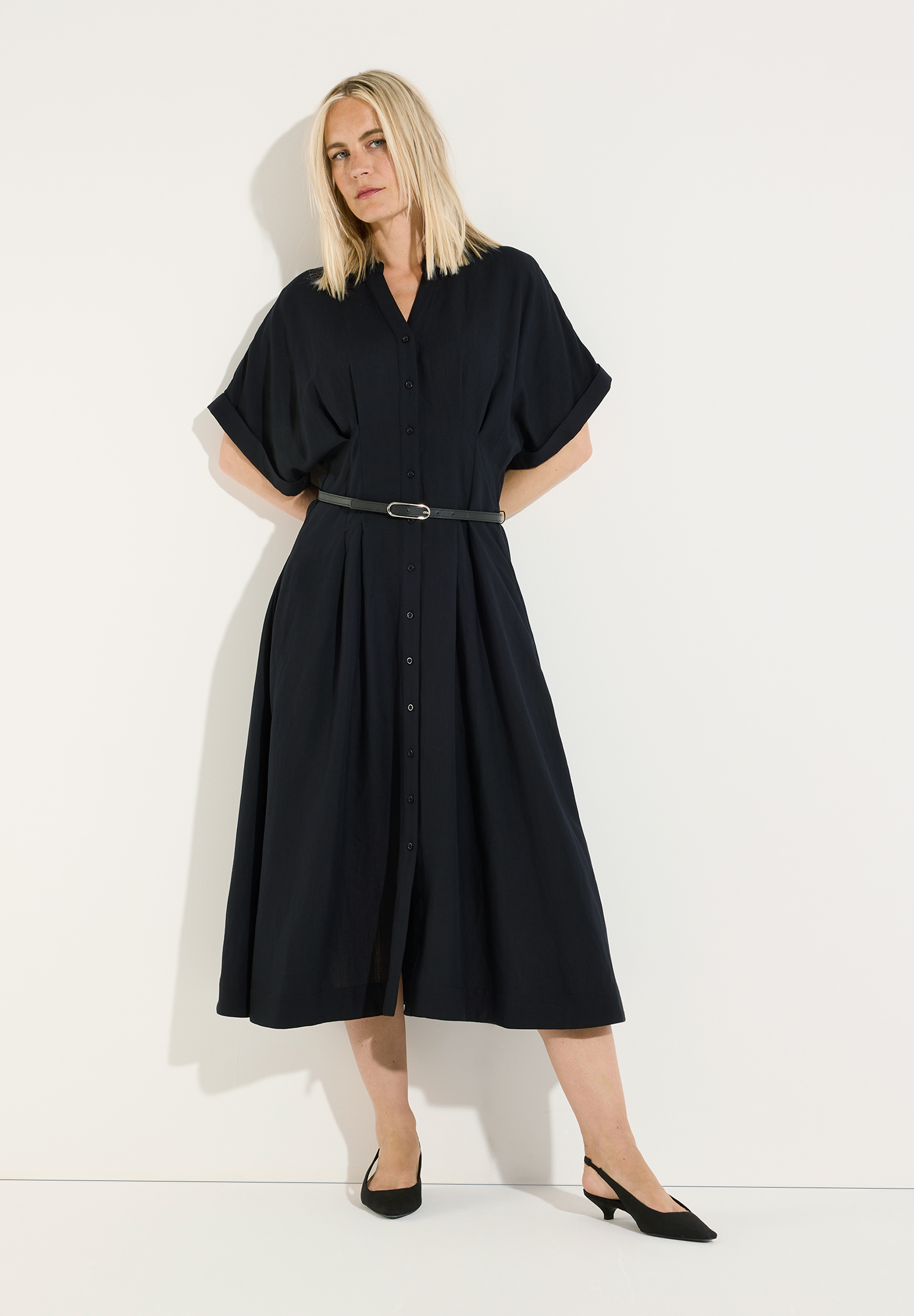 MORE & MORE schwarzes Hemdblusenkleid, eine Frau mit blonden Haaren posiert elegant vor weißem Hintergrund.