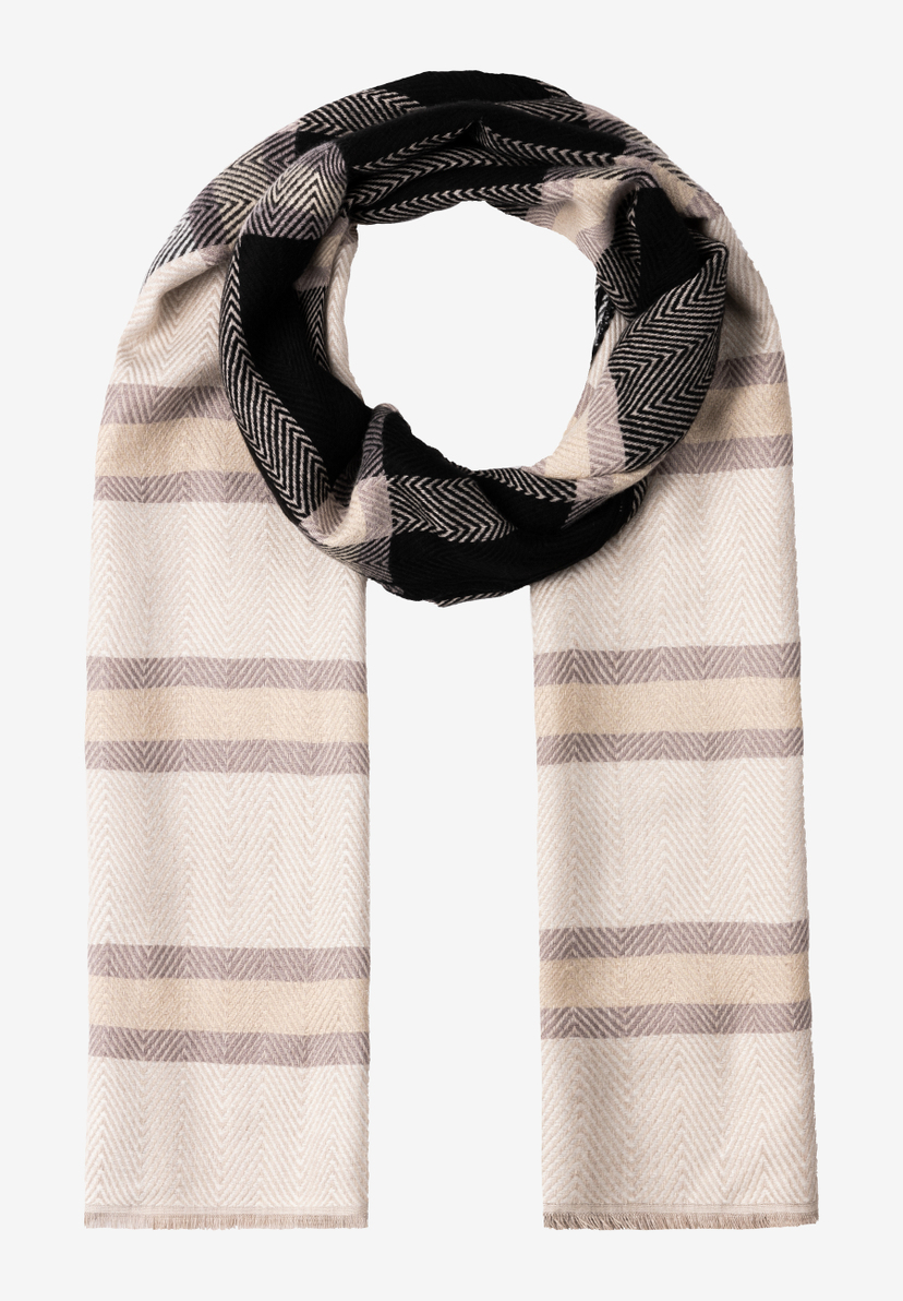 Ein MORE & MORE Accessoire: Ein beiger Schal mit breiten, hellbraunen Streifen und einem schwarz-weiß gemusterten Bereich liegt gewickelt. Ein MORE & MORE Accessoire: Ein beiger Schal mit breiten, hellbraunen Streifen und einem schwarz-weiß gemusterten Bereich liegt gewickelt.