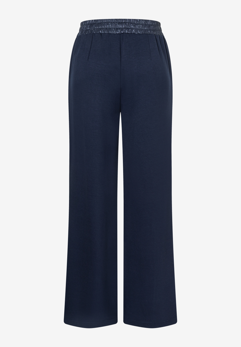 Eine marineblaue MORE & MORE Hose mit weitem Bein und elastischem Bund.