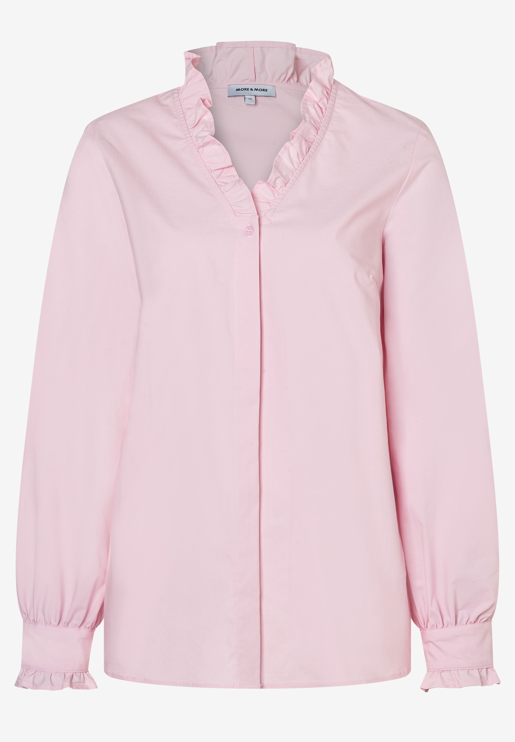 Eine rosafarbene MORE & MORE Bluse mit Rüschen am Kragen und Ärmeln. Eine rosafarbene MORE & MORE Bluse mit Rüschen am Kragen und Ärmeln.