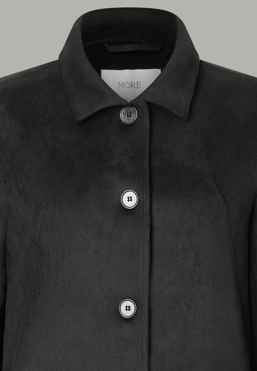 Nahaufnahme eines schwarzen MORE & MORE Blazers mit Knöpfen und Kragen. Nahaufnahme eines schwarzen MORE & MORE Blazers mit Knöpfen und Kragen.