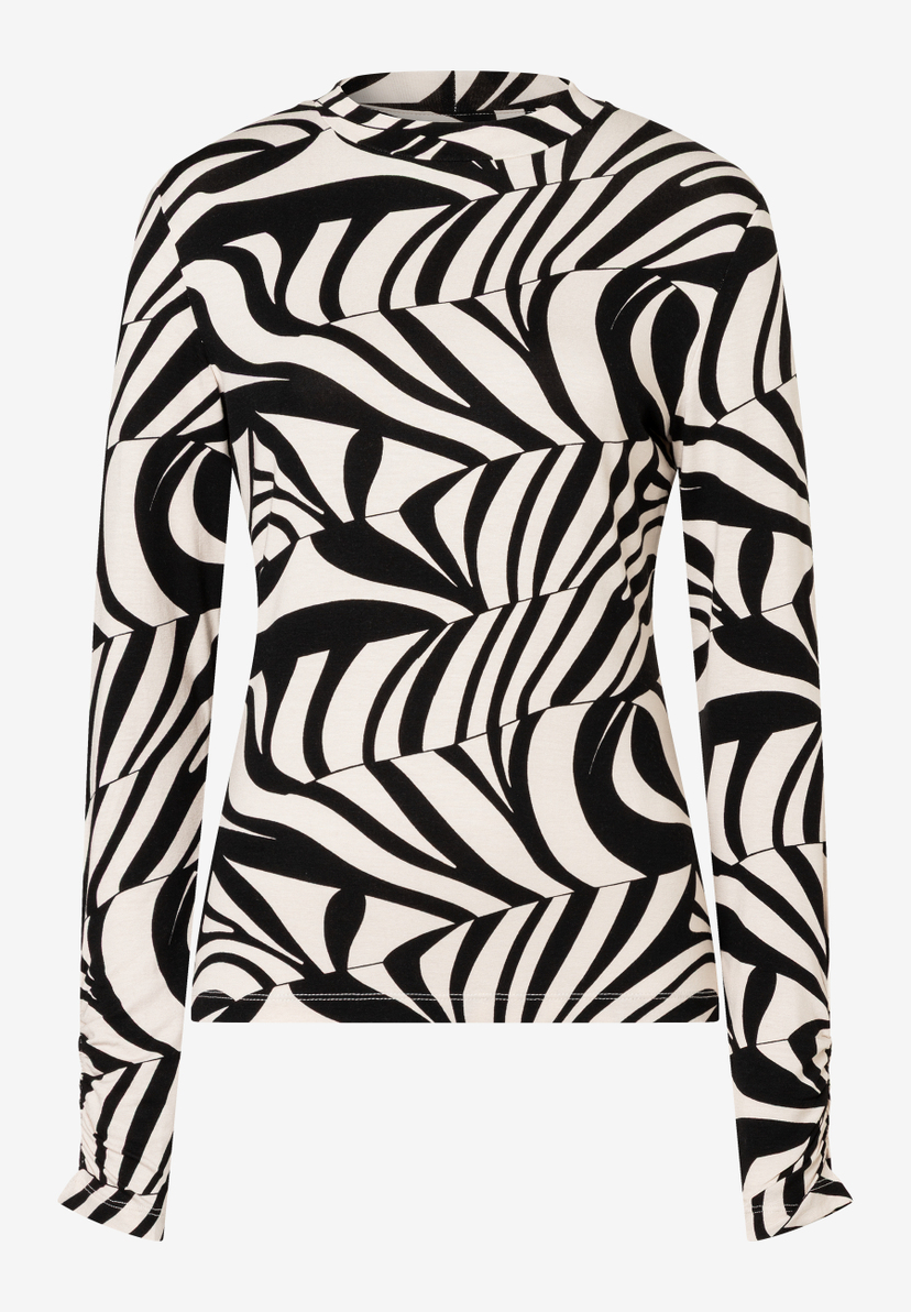 Ein MORE & MORE Oberteil mit auffälligem, abstraktem Schwarz-Weiß-Muster und langen Ärmeln. Ein MORE & MORE Oberteil mit auffälligem, abstraktem Schwarz-Weiß-Muster und langen Ärmeln.