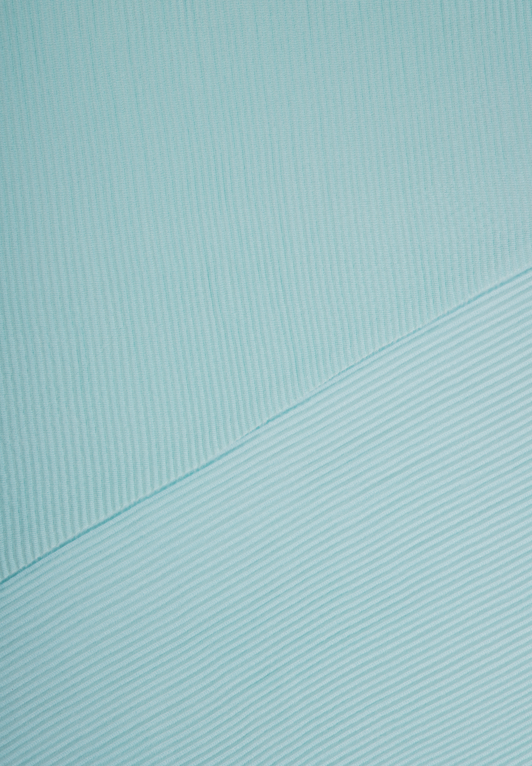 Nahaufnahme eines helltürkisen MORE & MORE Accessoires mit feiner, gerippter Struktur. Nahaufnahme eines helltürkisen MORE & MORE Accessoires mit feiner, gerippter Struktur.