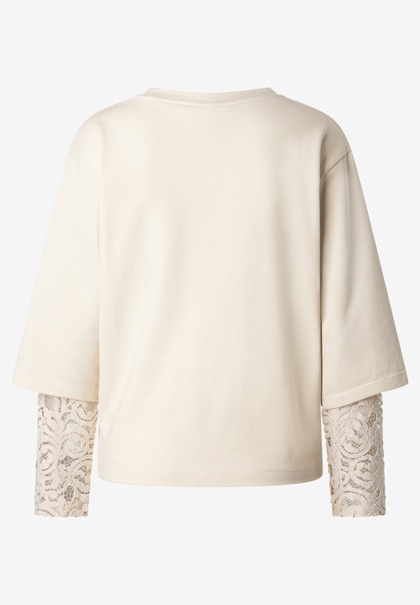 MORE & MORE Damen-Sweatshirt: Cremefarbenes Oberteil mit kurzen Ärmeln, unter denen lange, cremefarbene Spitzenärmel hervorblitzen. MORE & MORE Damen-Sweatshirt: Cremefarbenes Oberteil mit kurzen Ärmeln, unter denen lange, cremefarbene Spitzenärmel hervorblitzen.