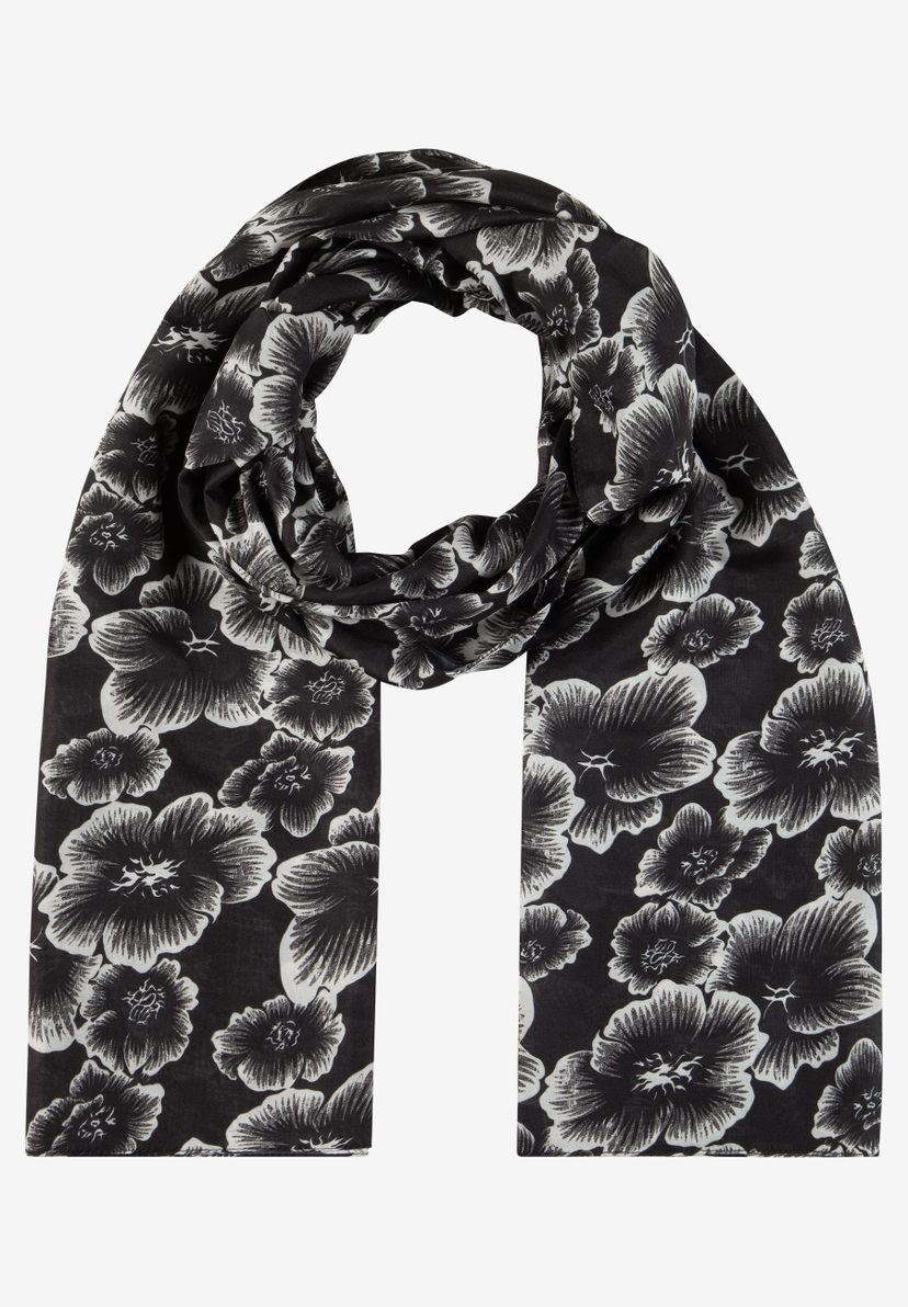 MORE & MORE Accessoire: Schwarz-weißer Schal mit Blumenmuster, elegant um den Hals drapiert vor grauem Hintergrund. MORE & MORE Accessoire: Schwarz-weißer Schal mit Blumenmuster, elegant um den Hals drapiert vor grauem Hintergrund.