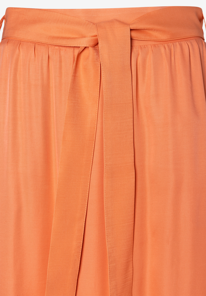 Nahaufnahme eines orangefarbenen MORE & MORE Rocks aus Viskose mit Bindegürtel. Nahaufnahme eines orangefarbenen MORE & MORE Rocks aus Viskose mit Bindegürtel.