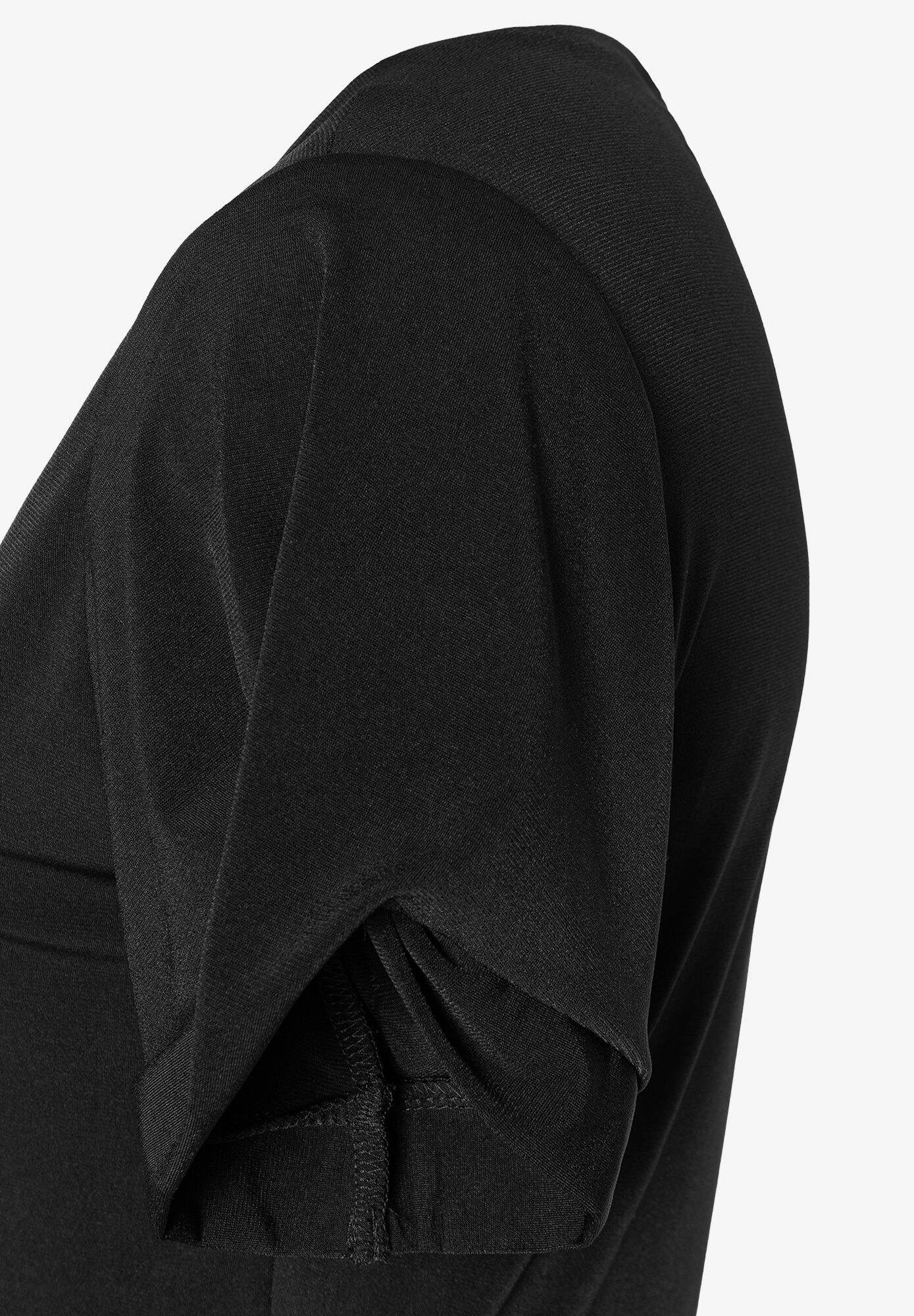 Detailaufnahme eines schwarzen MORE & MORE Oberteils aus Jersey mit gerafftem Ärmel. Detailaufnahme eines schwarzen MORE & MORE Oberteils aus Jersey mit gerafftem Ärmel.