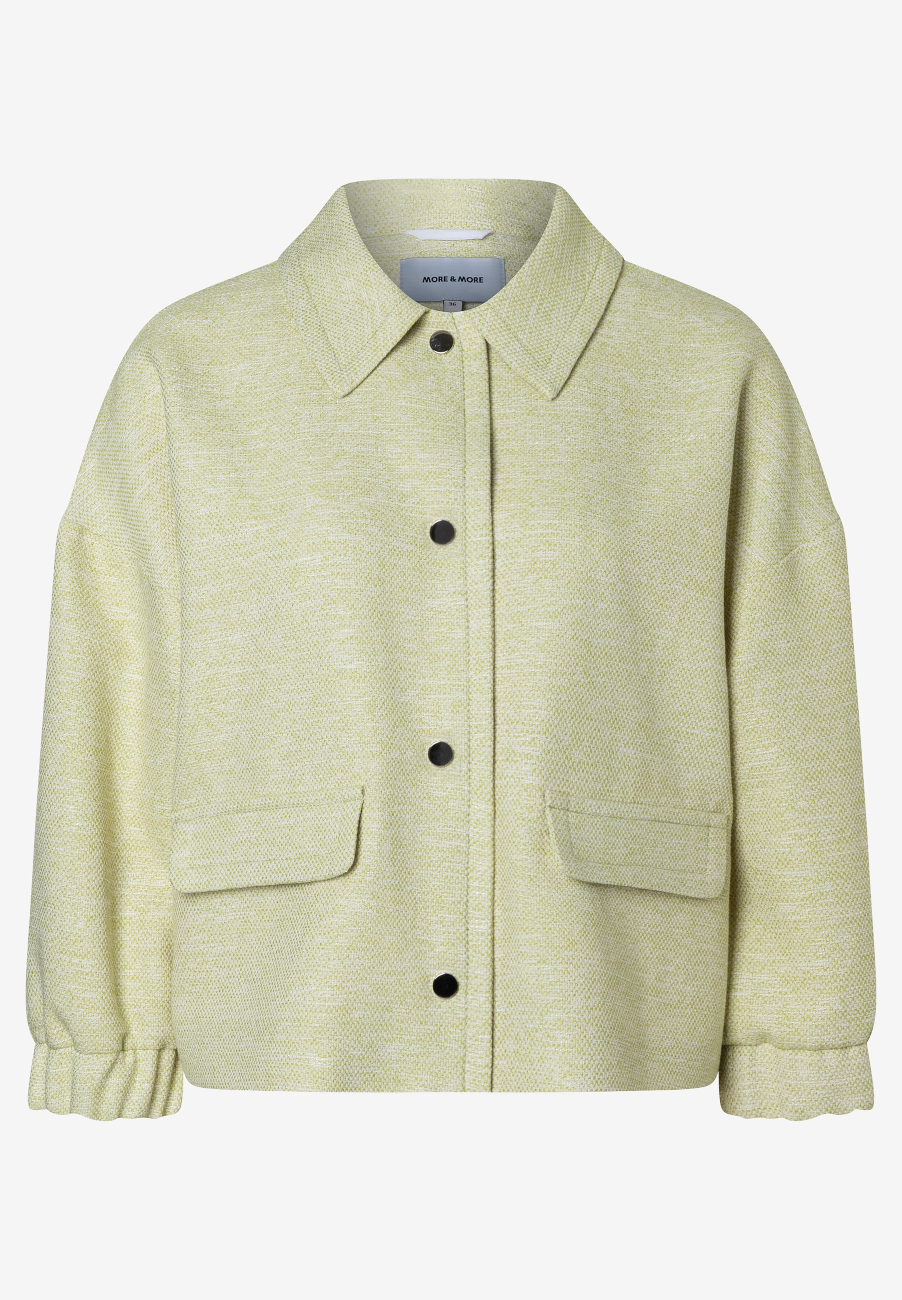 Ein hellgrüner Bouclé-Blazer von MORE & MORE mit Knöpfen und Taschen. Ein hellgrüner Bouclé-Blazer von MORE & MORE mit Knöpfen und Taschen.