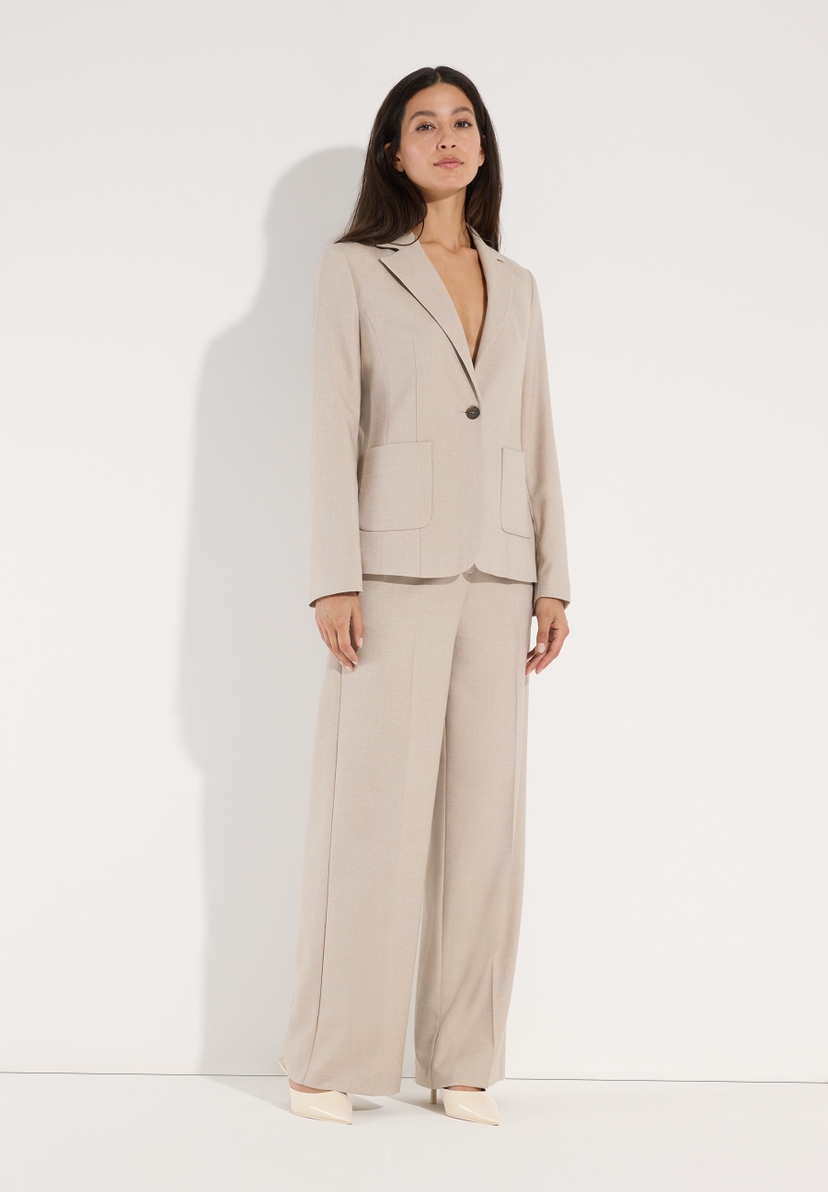 MORE & MORE Blazer Webware in Beige getragen von einem Model vor hellem Hintergrund. Die Hose hat einen weiten Schnitt. MORE & MORE Blazer Webware in Beige getragen von einem Model vor hellem Hintergrund. Die Hose hat einen weiten Schnitt.