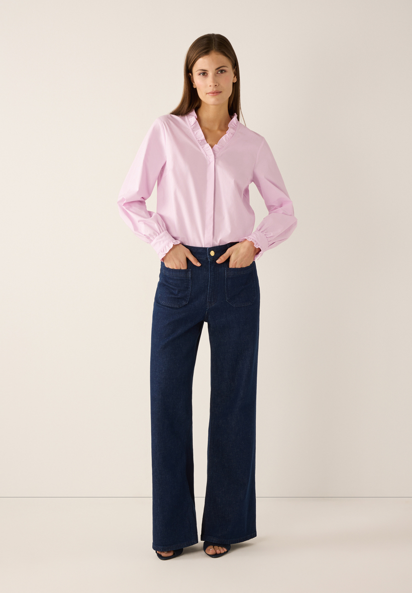 Eine Frau in MORE & MORE Bluse aus Popeline und Jeans mit Händen in den Taschen. Eine Frau in MORE & MORE Bluse aus Popeline und Jeans mit Händen in den Taschen.