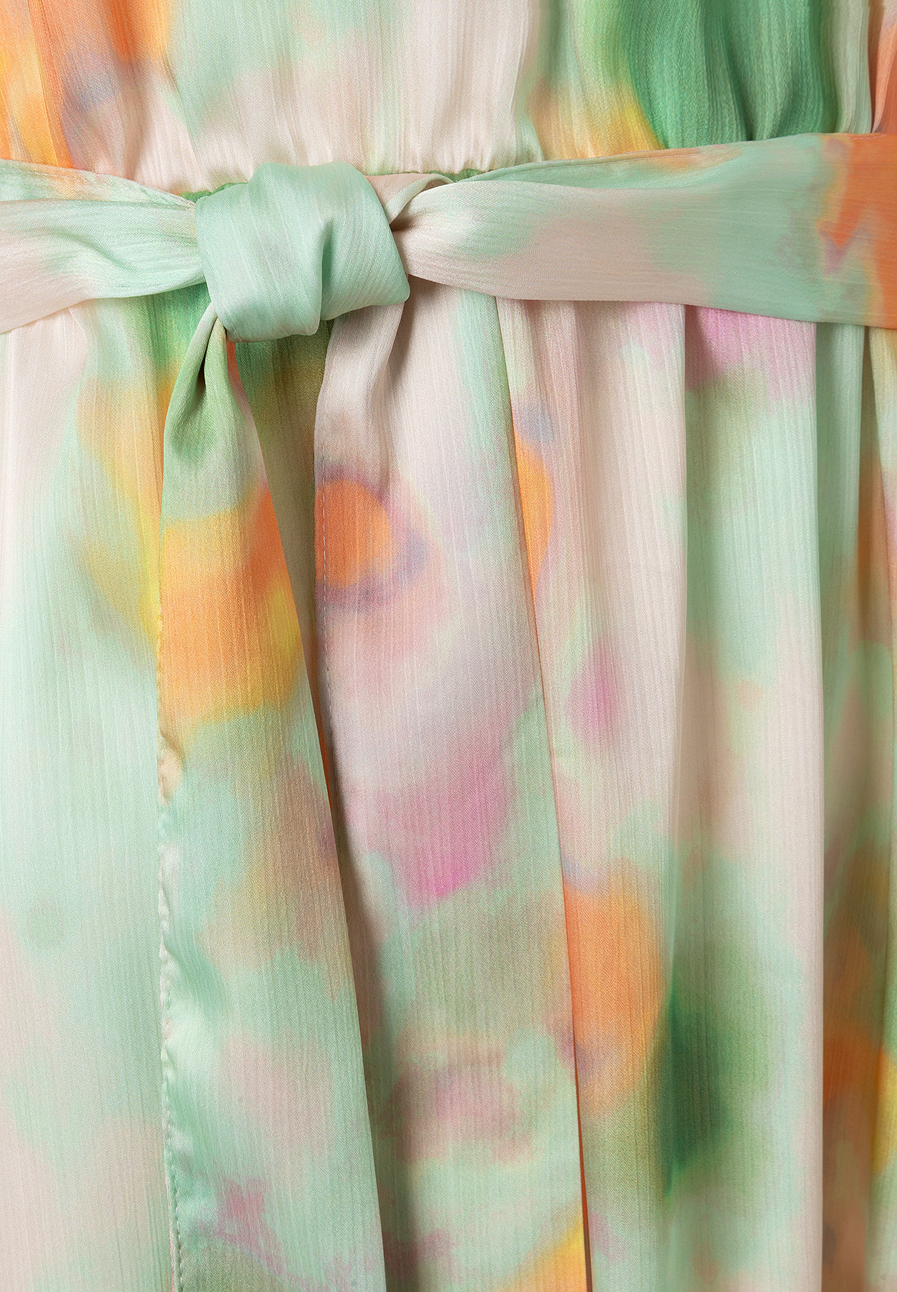 Nahaufnahme eines Oberteils von MORE & MORE mit Chiffon und fließendem, leichtem Stoff. Ein Knoten ist gebunden. Nahaufnahme eines Oberteils von MORE & MORE mit Chiffon und fließendem, leichtem Stoff. Ein Knoten ist gebunden.