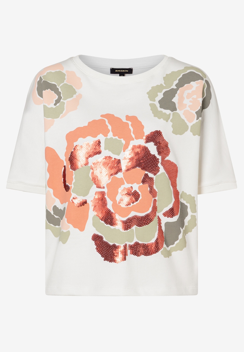 Ein weißes MORE & MORE Sweatshirt mit floralem Muster und glitzernden Pailletten. Ein weißes MORE & MORE Sweatshirt mit floralem Muster und glitzernden Pailletten.