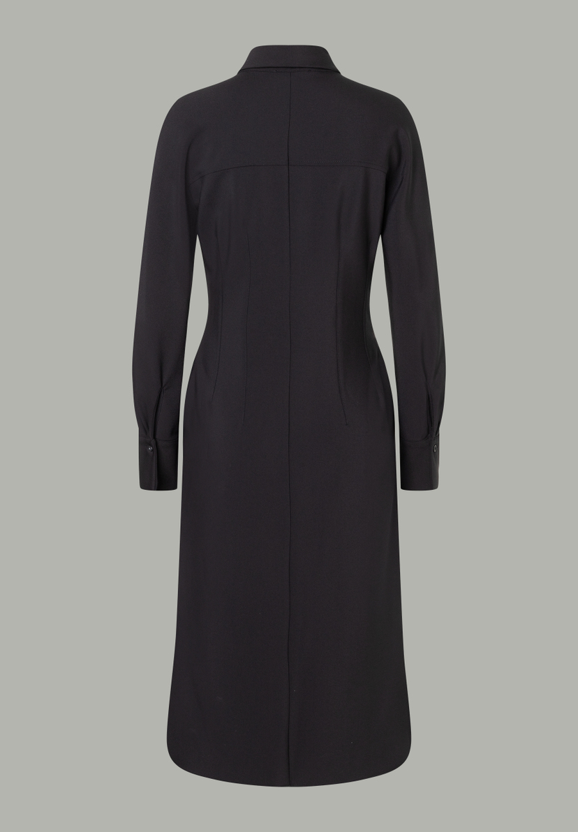 Ein schwarzes MORE & MORE Oberteil mit langen Ärmeln und Knopfmanschetten. Ein schwarzes MORE & MORE Oberteil mit langen Ärmeln und Knopfmanschetten.