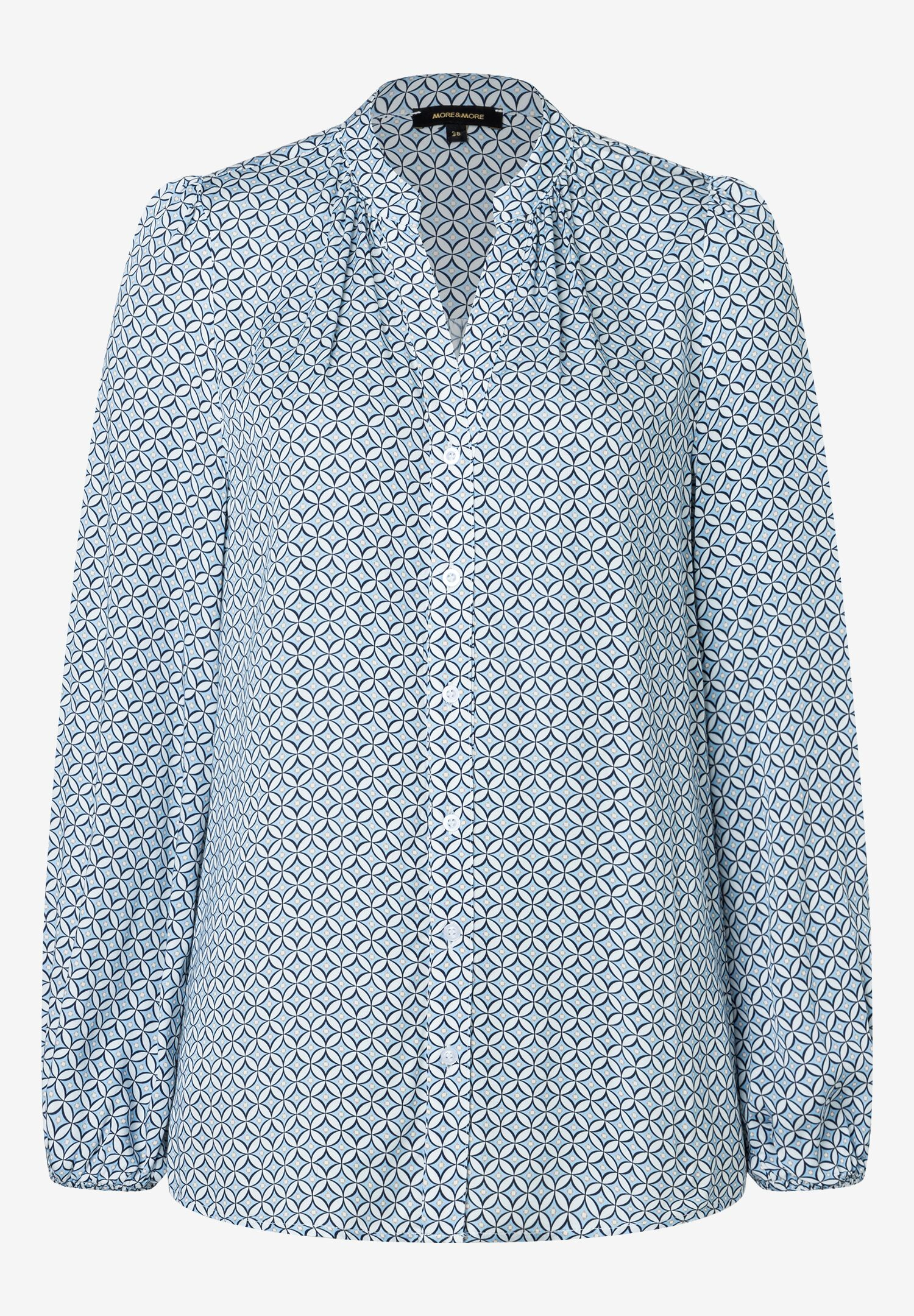 Eine MORE & MORE Bluse mit blauem geometrischem Muster und langen Ärmeln. Eine MORE & MORE Bluse mit blauem geometrischem Muster und langen Ärmeln.