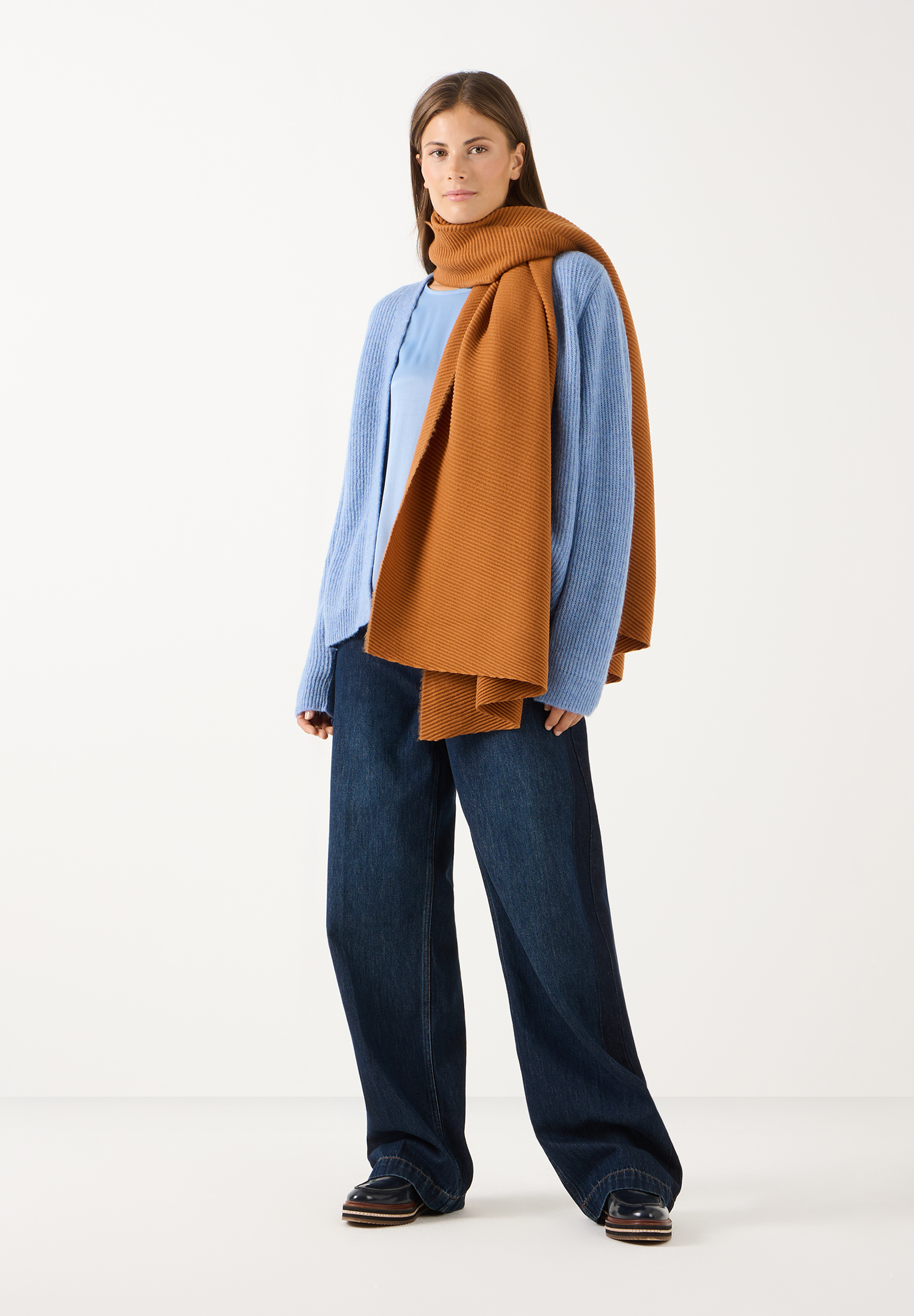 MORE & MORE Jeans: Model trägt eine dunkelblaue Jeans, einen hellblauen Pullover und einen braunen Schal vor weißem Hintergrund.
