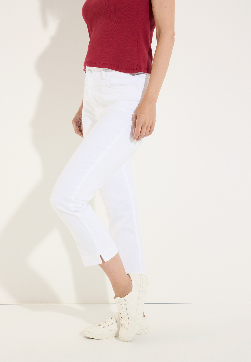 MORE & MORE Jeans: Weiße Denim-Jeans mit hohem Bund und seitlichen Schlitzen am Knöchel. Hinten eine gemusterte Bluse. MORE & MORE Jeans: Weiße Denim-Jeans mit hohem Bund und seitlichen Schlitzen am Knöchel. Hinten eine gemusterte Bluse.