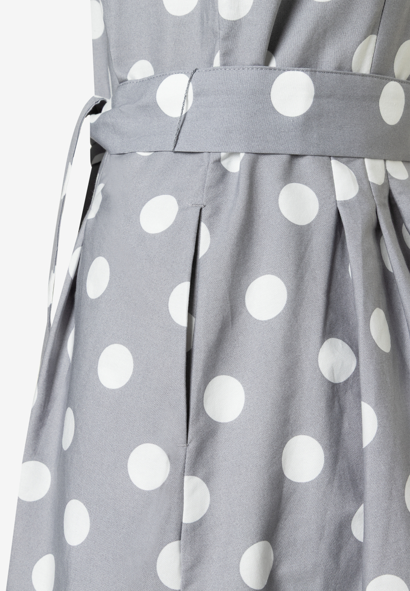 Detailaufnahme eines MORE & MORE Oberteils mit weißen Punkten auf grauem Grund und einem passenden Stoffgürtel.