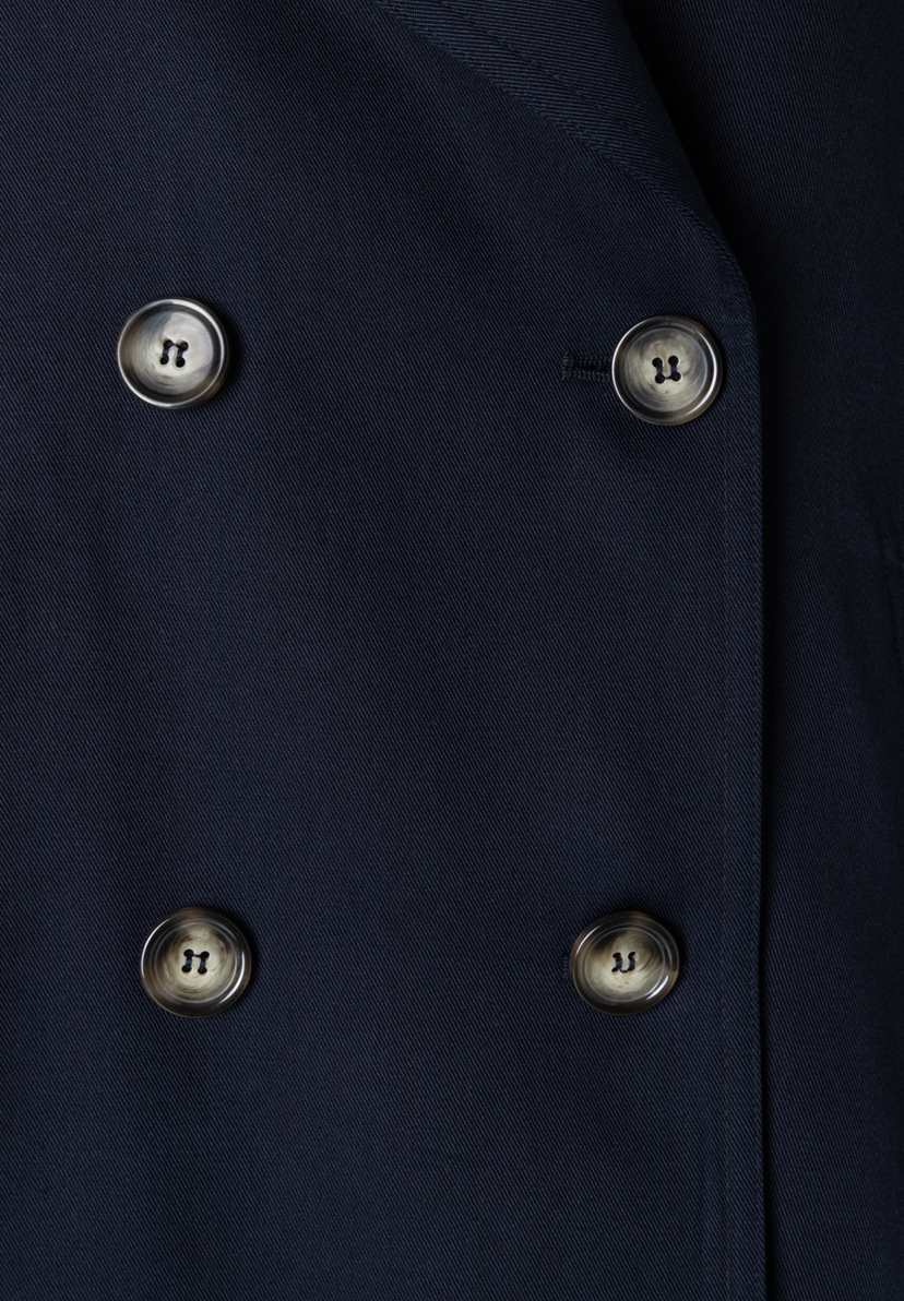 Detailansicht eines MORE & MORE Oberteils aus Twill mit vier Knöpfen. Detailansicht eines MORE & MORE Oberteils aus Twill mit vier Knöpfen.