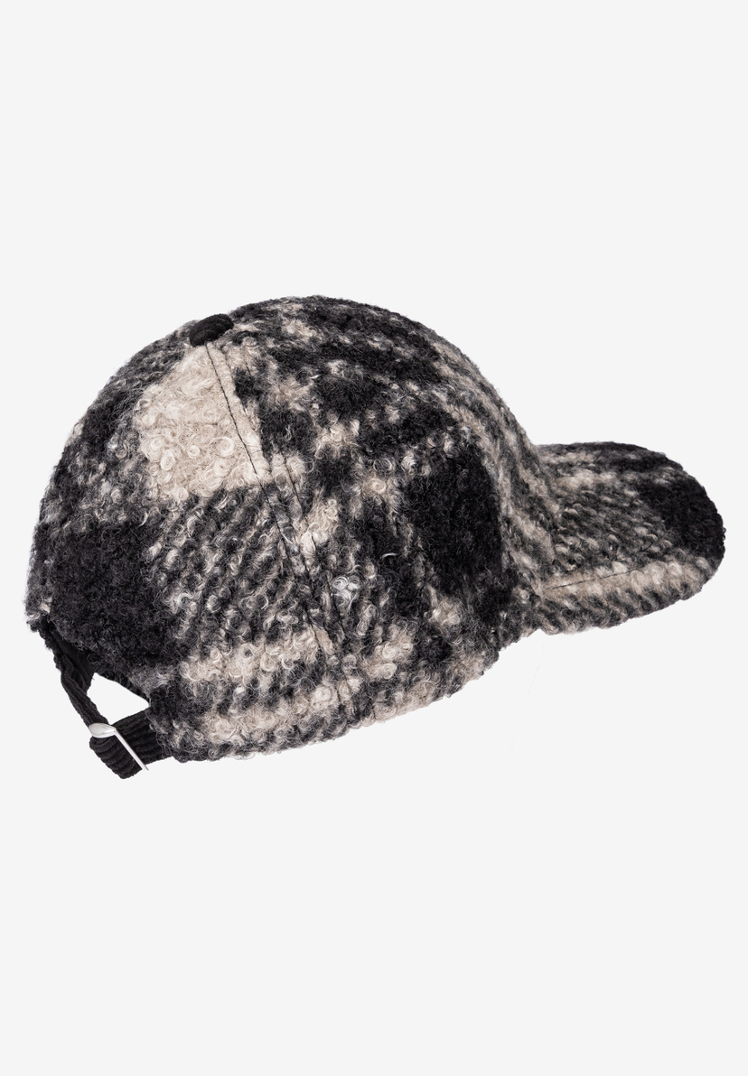 MORE & MORE Accessoire: Eine schwarz-weiß gemusterte Baseballkappe aus Bouclé-Stoff, Ansicht von der Seite.