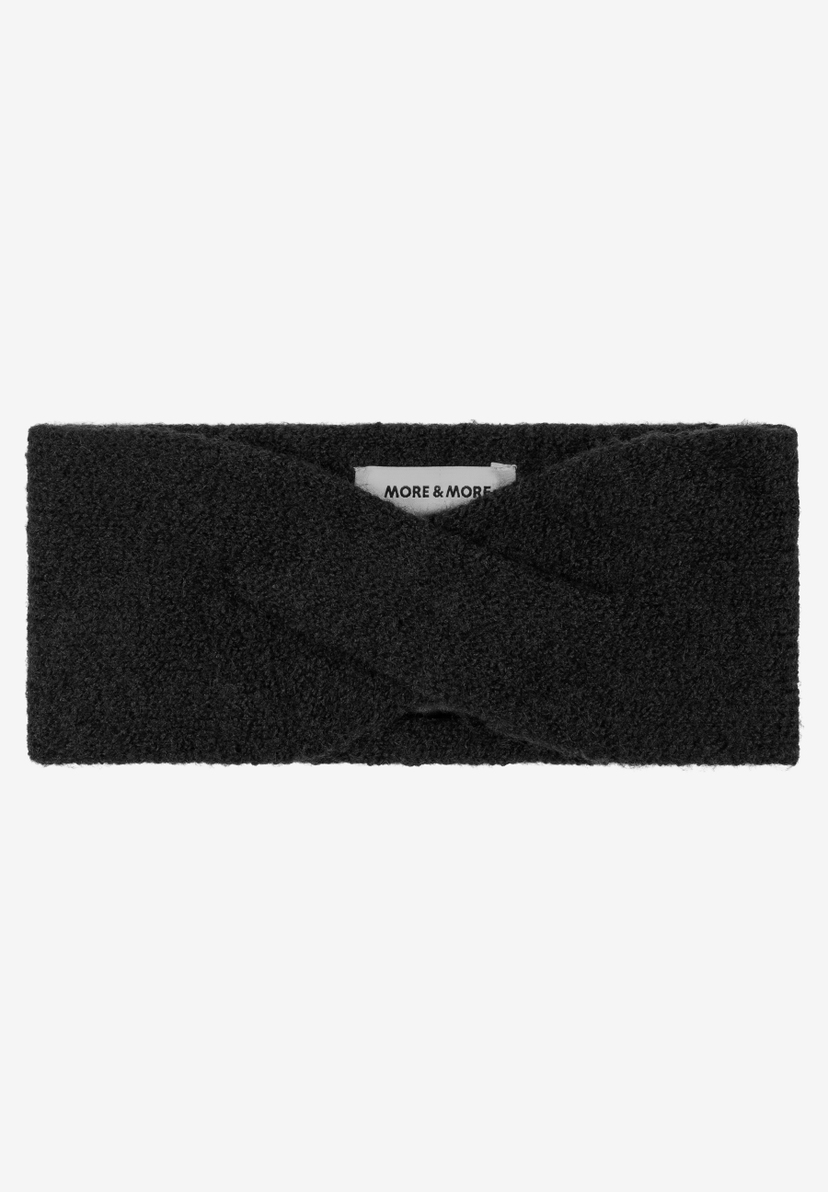 MORE & MORE schwarzes Stirnband aus flauschigem Stoff. Ein Accessoire für Damen, im Studio auf weißem Hintergrund. MORE & MORE schwarzes Stirnband aus flauschigem Stoff. Ein Accessoire für Damen, im Studio auf weißem Hintergrund.