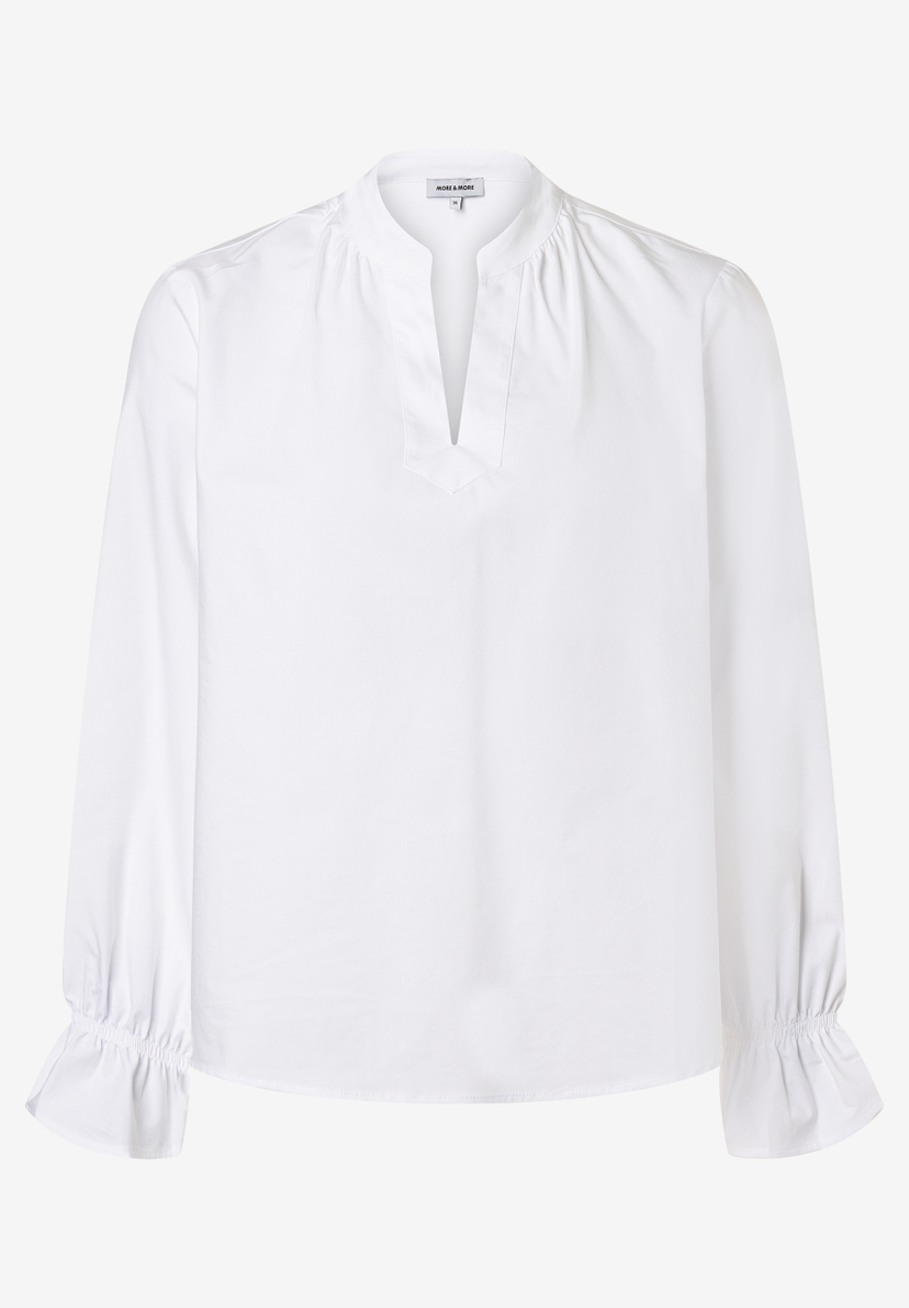 Weiße Bluse von MORE & MORE mit V-Ausschnitt und langen Ärmeln mit Rüschen am Saum. Weiße Bluse von MORE & MORE mit V-Ausschnitt und langen Ärmeln mit Rüschen am Saum.
