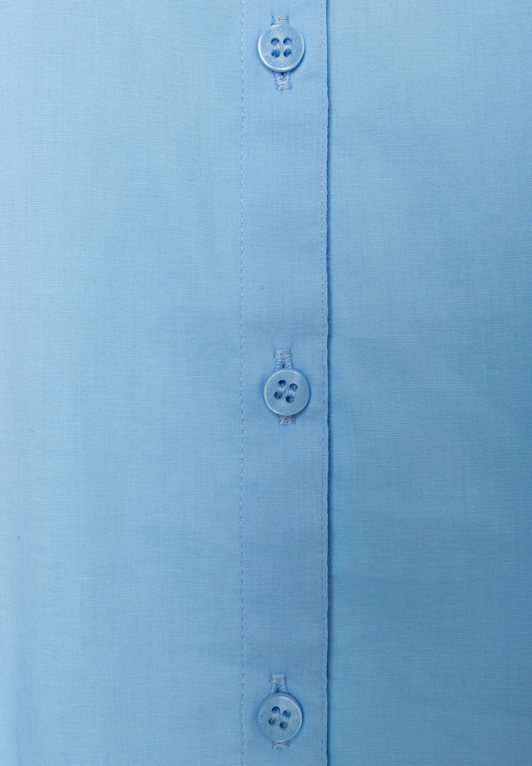 Nahaufnahme einer hellblauen MORE & MORE Bluse aus Popeline mit Knöpfen. Nahaufnahme einer hellblauen MORE & MORE Bluse aus Popeline mit Knöpfen.