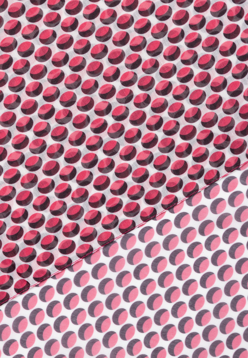 Detailaufnahme eines Accessoires von MORE & MORE mit einem Muster aus roten und rosa Punkten auf weißem Stoff. Detailaufnahme eines Accessoires von MORE & MORE mit einem Muster aus roten und rosa Punkten auf weißem Stoff.