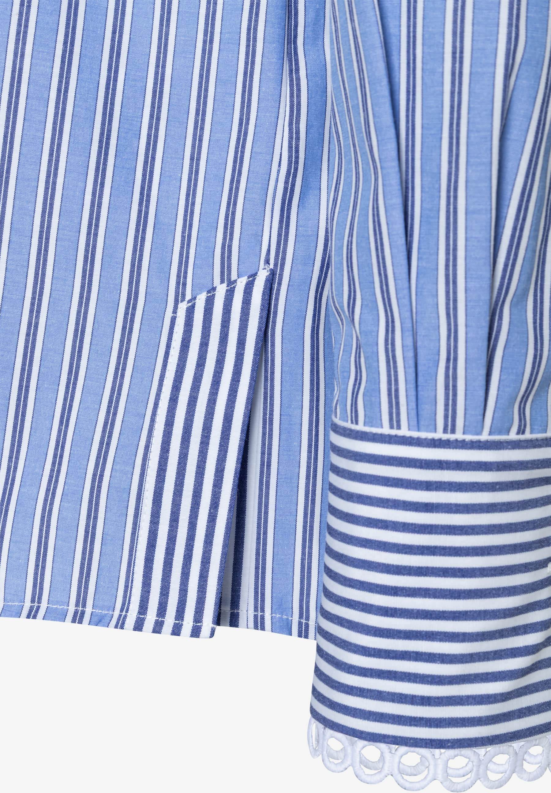 Detailansicht einer gestreiften MORE & MORE Bluse mit Manschette und Seitenschlitz. Detailansicht einer gestreiften MORE & MORE Bluse mit Manschette und Seitenschlitz.